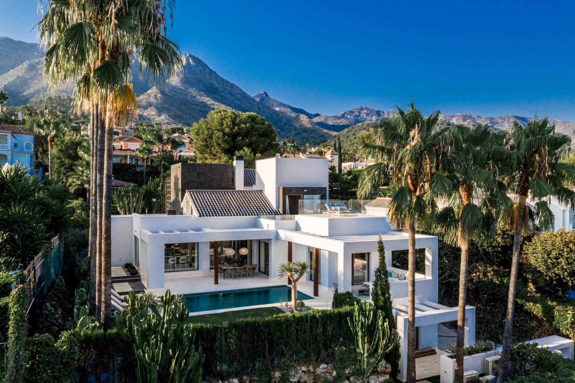 A white modern villa among palms below La Concha, Marbella