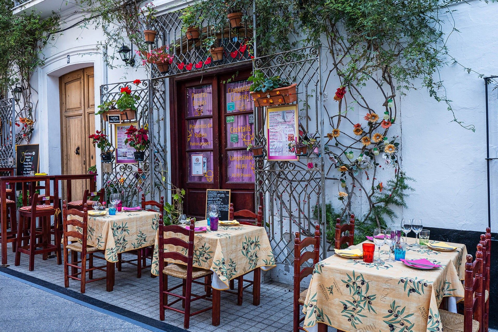 Café tables under flowers in Marbella old town