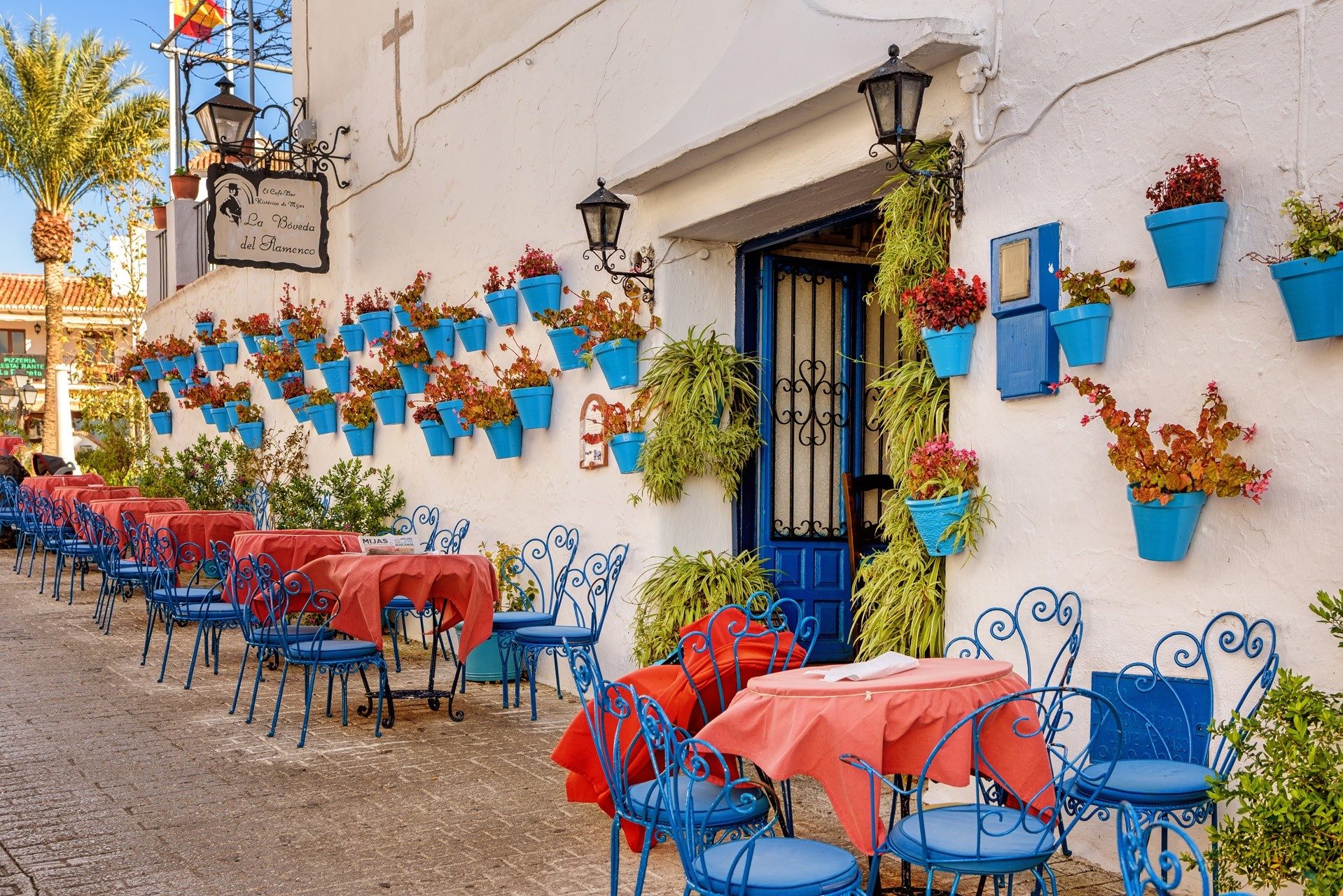 Blue flowerpots and café tables in Mijas Pueblo
