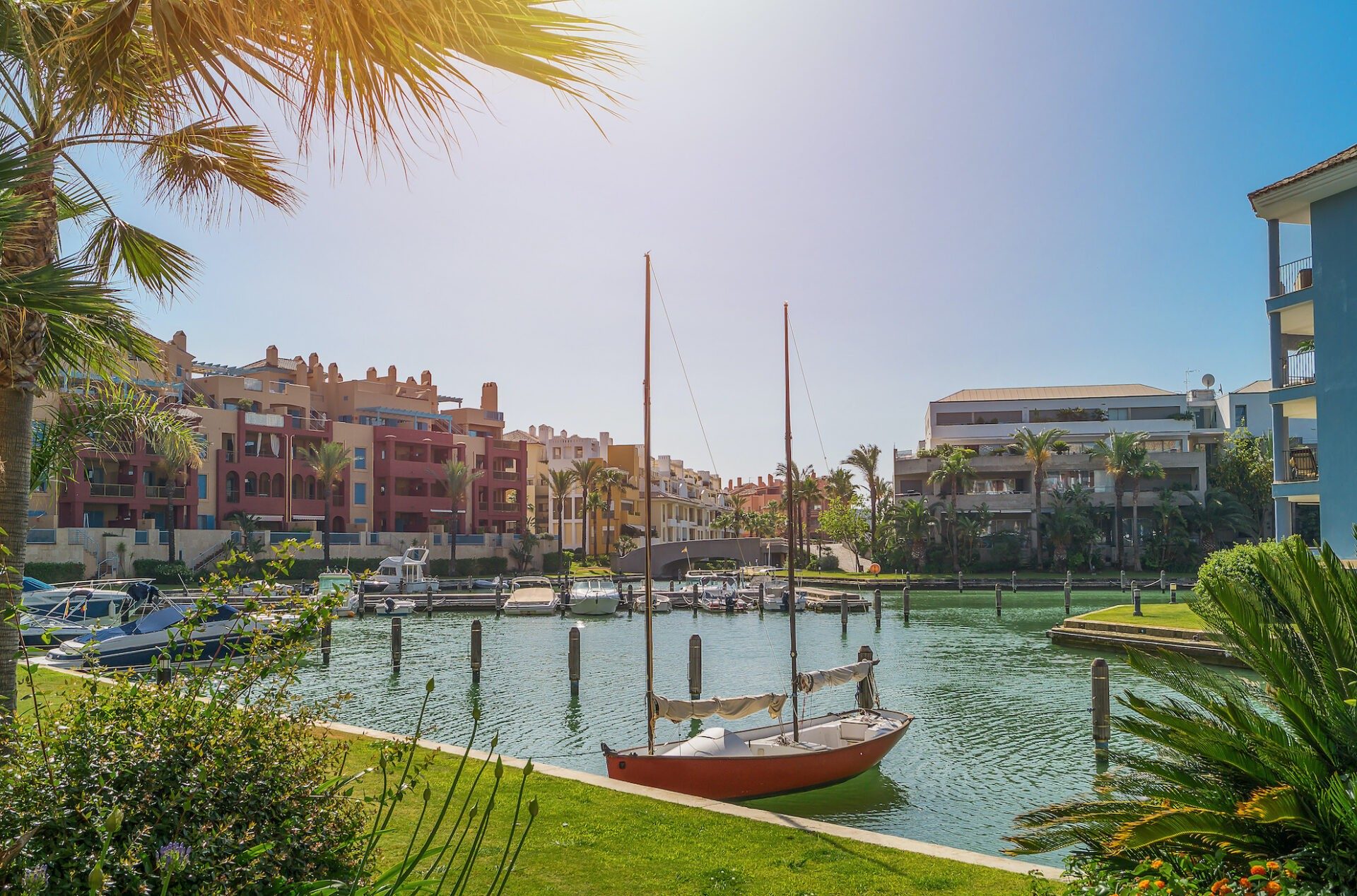 A sailing boat on a canal in Sotogrande marina